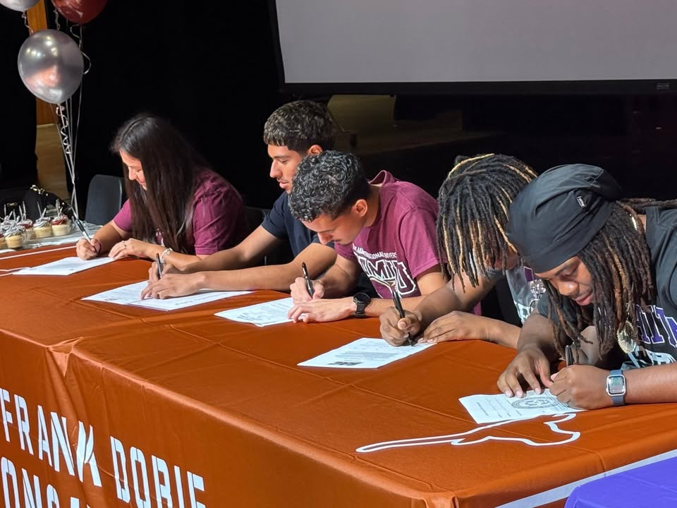 On Dobie Signing Day, athletes celebrated their dreams, committing to universities in a spirited atmosphere.