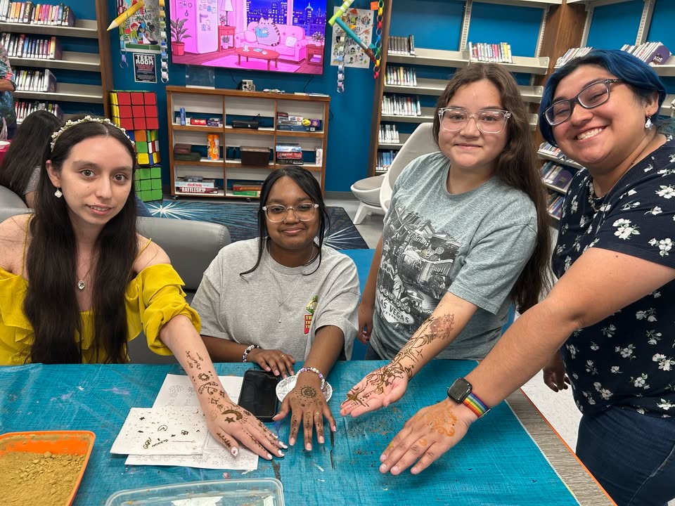 Re-cap of Macy Ulbrict’s Henna Love making the Library a creative playground where everyone splashed their imaginations across their arms.