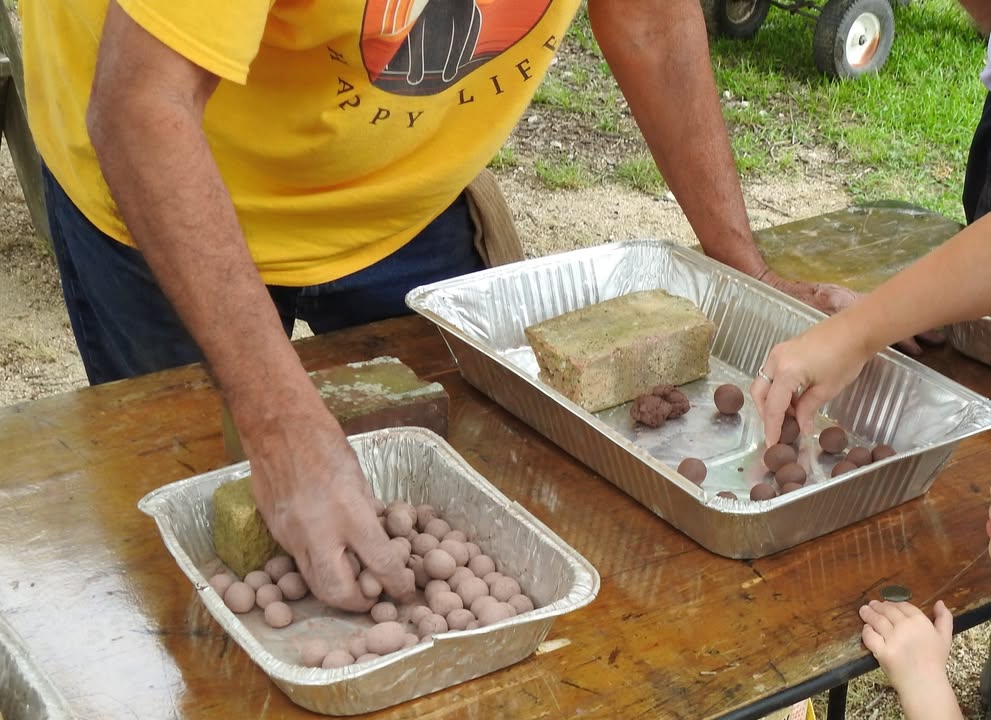 Armand Bayou EcoCampers craft seedballs for prairie conservation.